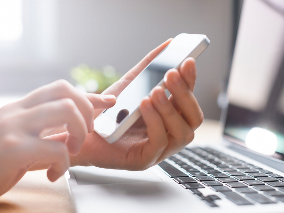 Hands,Using,Phone,In,Front,Of,Computer,,Home,Work,Place,